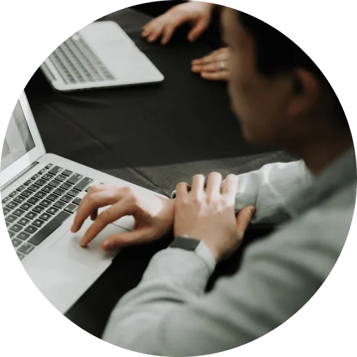 Team collaborating around a laptop